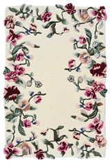 Floral patterned rug with pink, red, and green flowers on a beige background